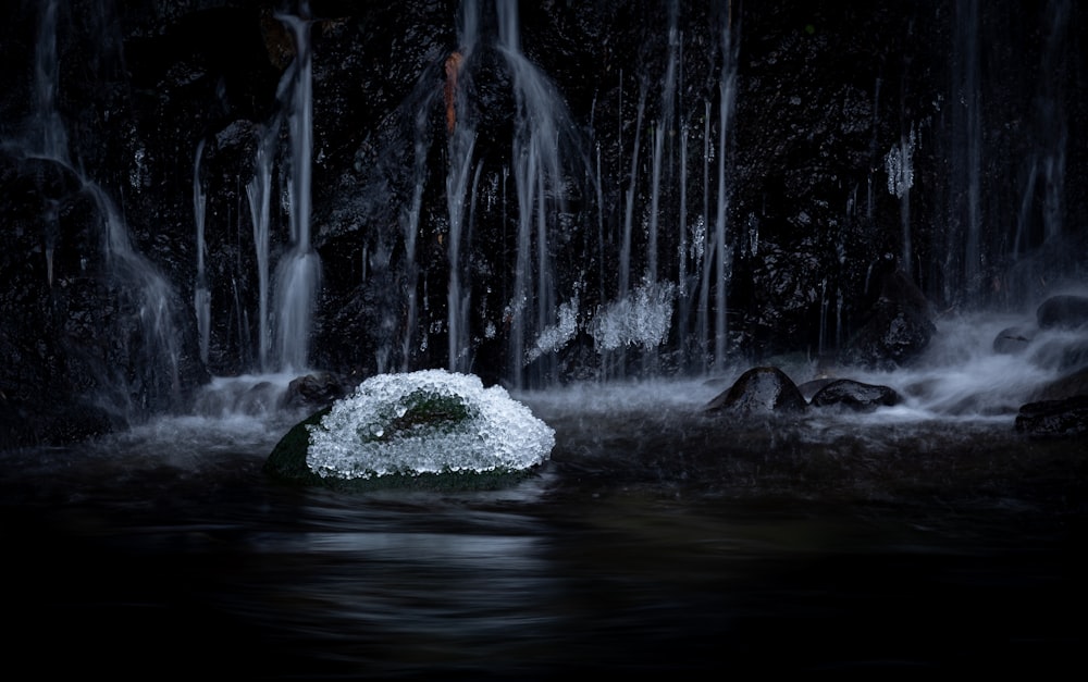 a small rock in the middle of a body of water