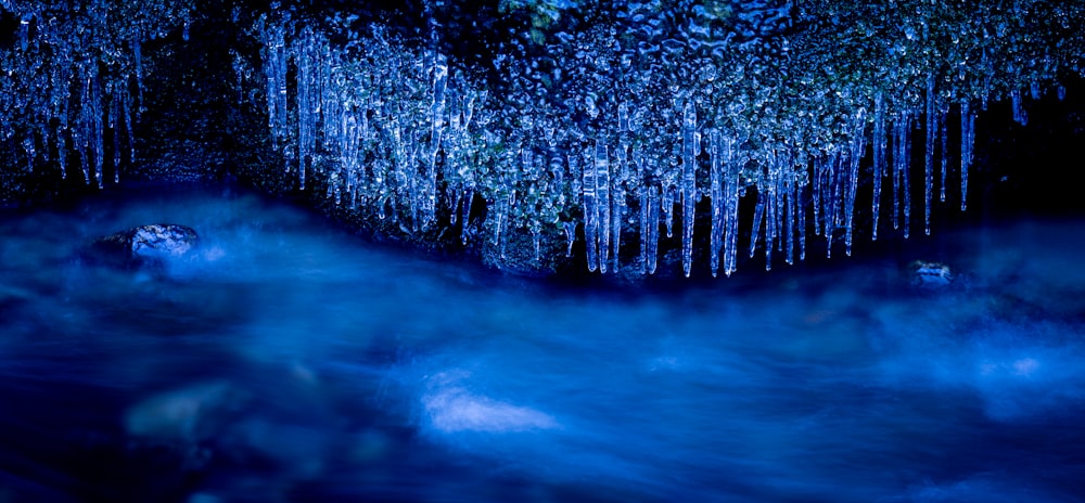 a group of icicles hanging from the ceiling of a cave