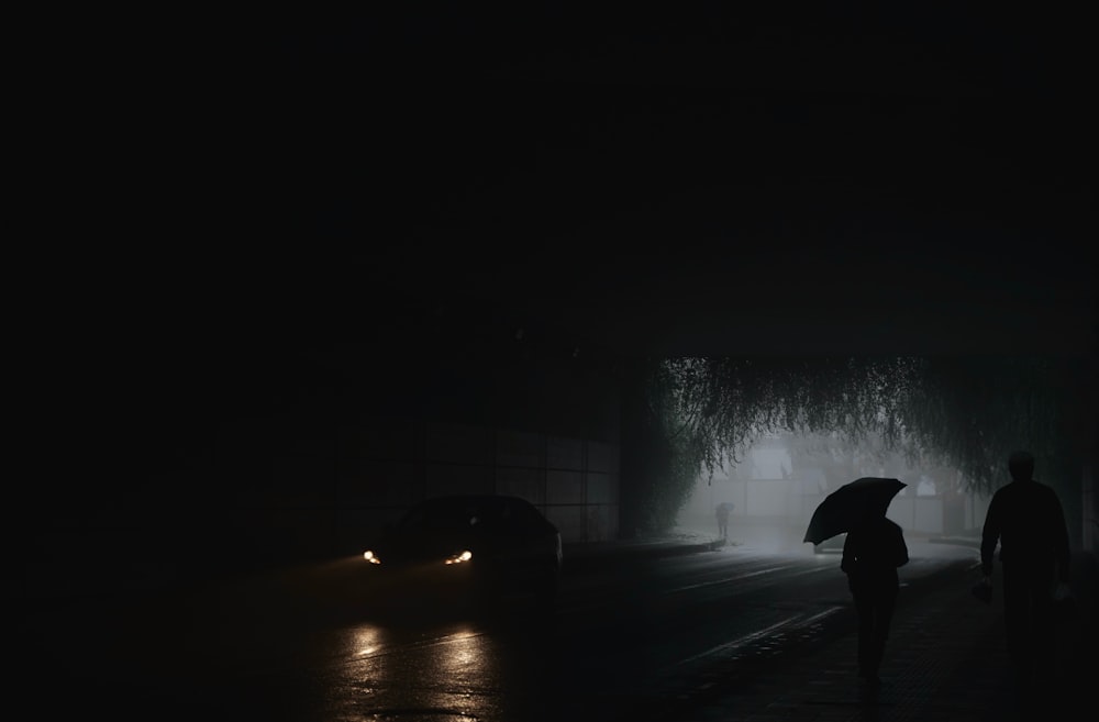 a person walking down a street holding an umbrella