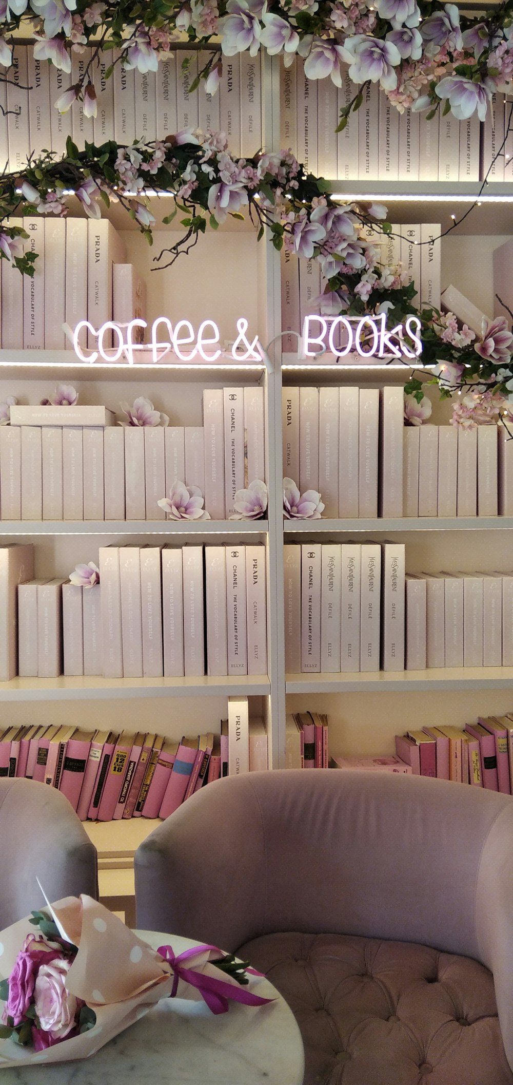 a room filled with lots of books and flowers