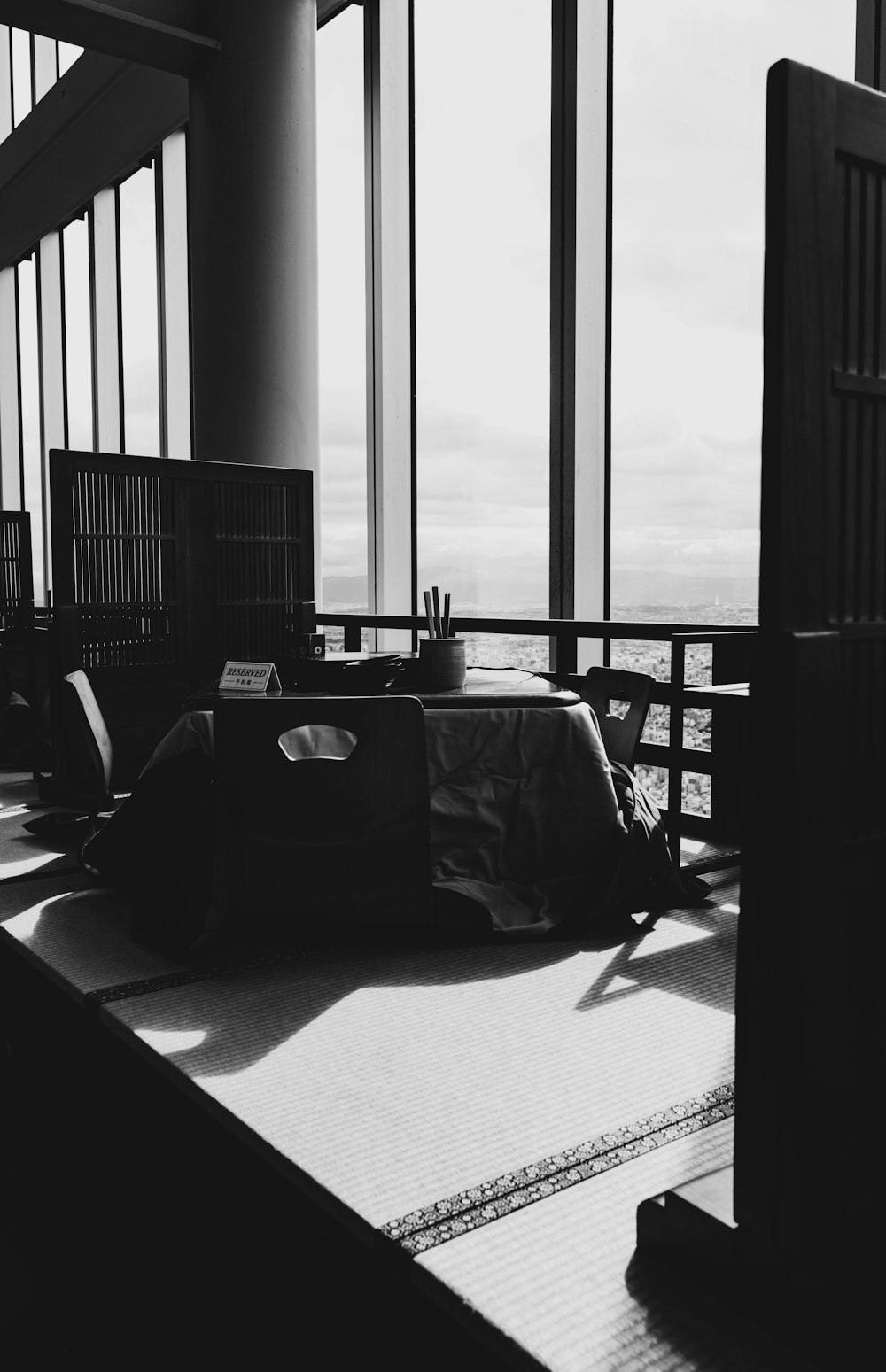 a black and white photo of a person sleeping on a bed