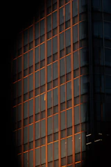 Modern high-rise building facade featuring sleek aluminum alloy windows at sunset
