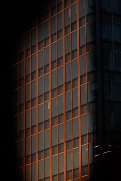 Modern high-rise building facade featuring sleek aluminum alloy windows at sunset