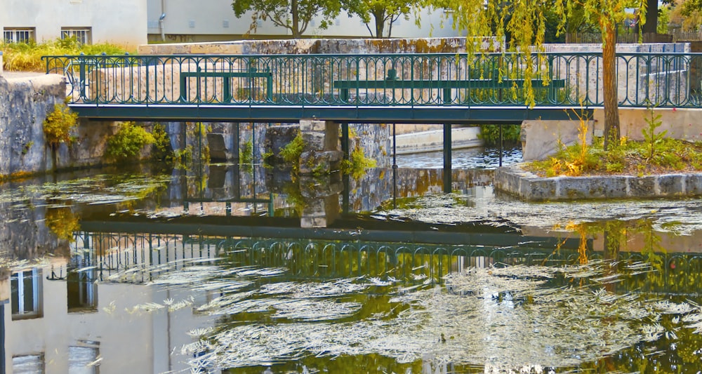 a bridge over a body of water next to a building