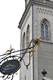 A refined private school website homepage displayed on a high-resolution screen with deep charcoal and gold accents.
