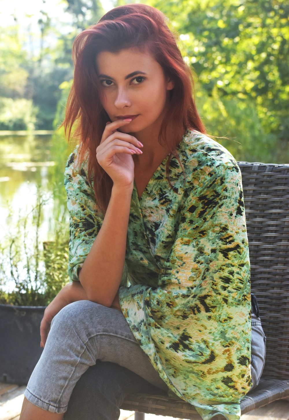 a woman with red hair sitting on a bench