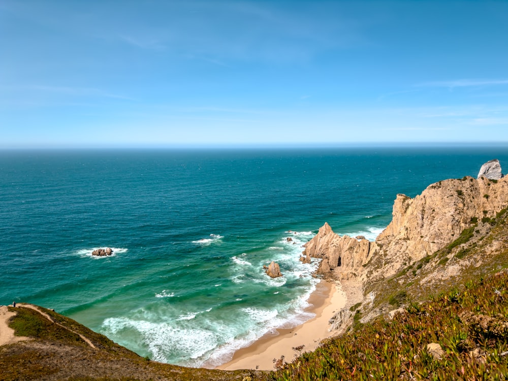 a view of the ocean from the top of a hill