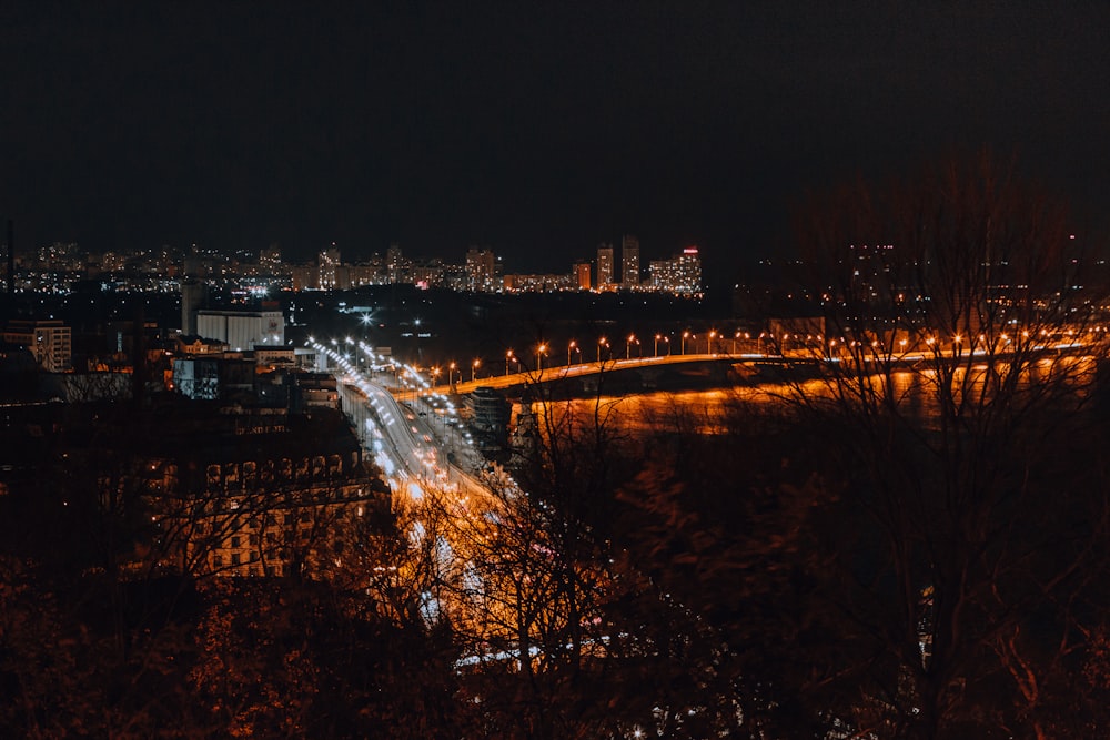 a view of a city at night from a hill