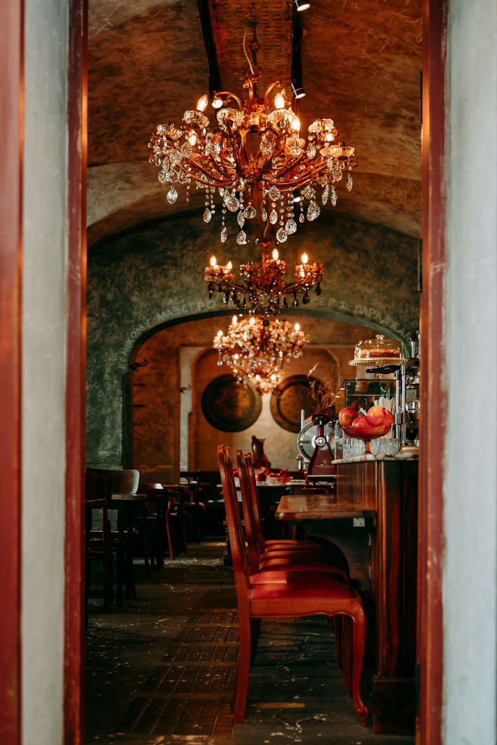 a dining room with a chandelier hanging from the ceiling