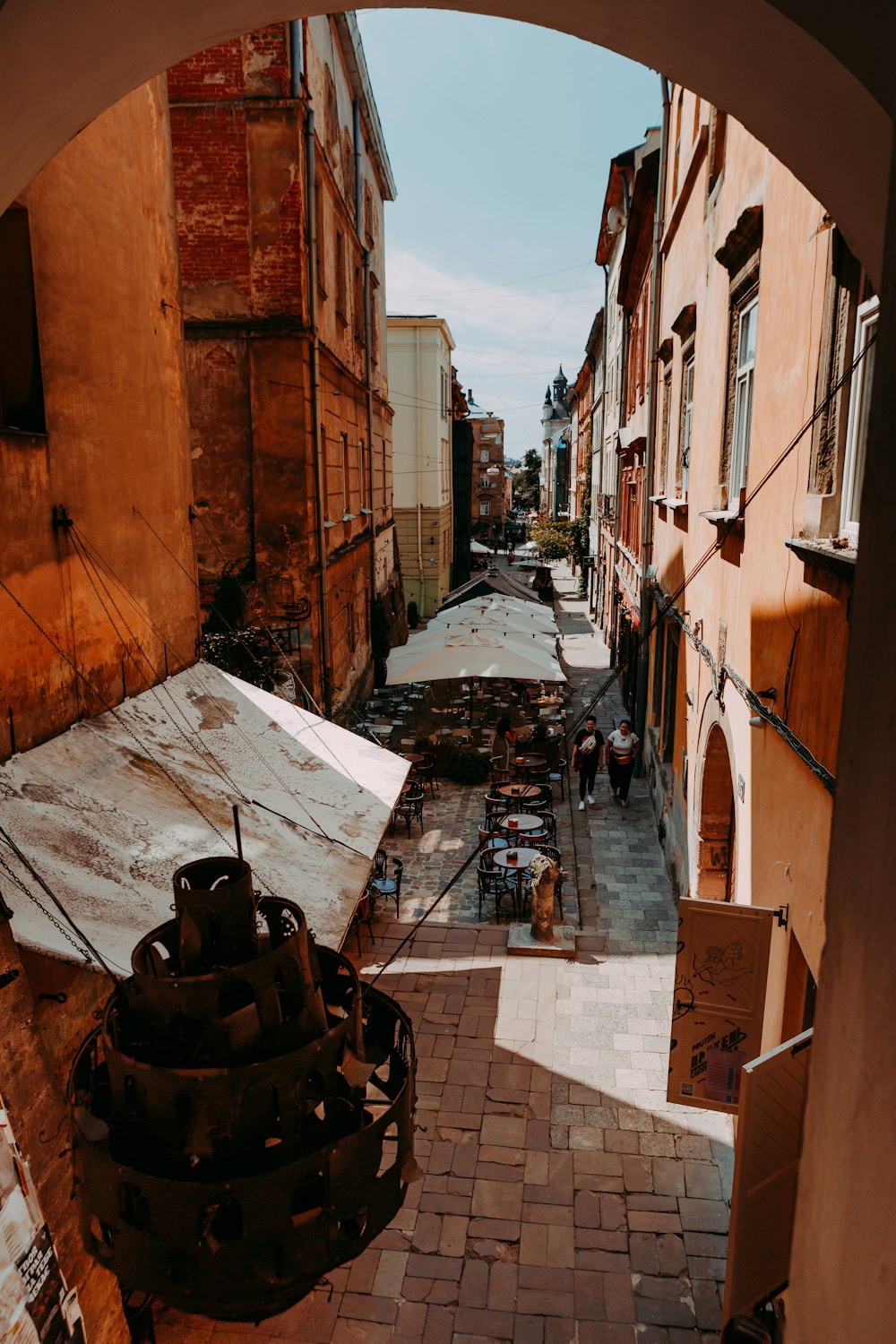 a view of a street through an arch in a building