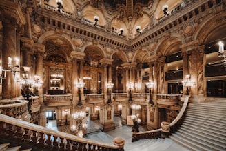 a grand staircase in a building with chandeliers