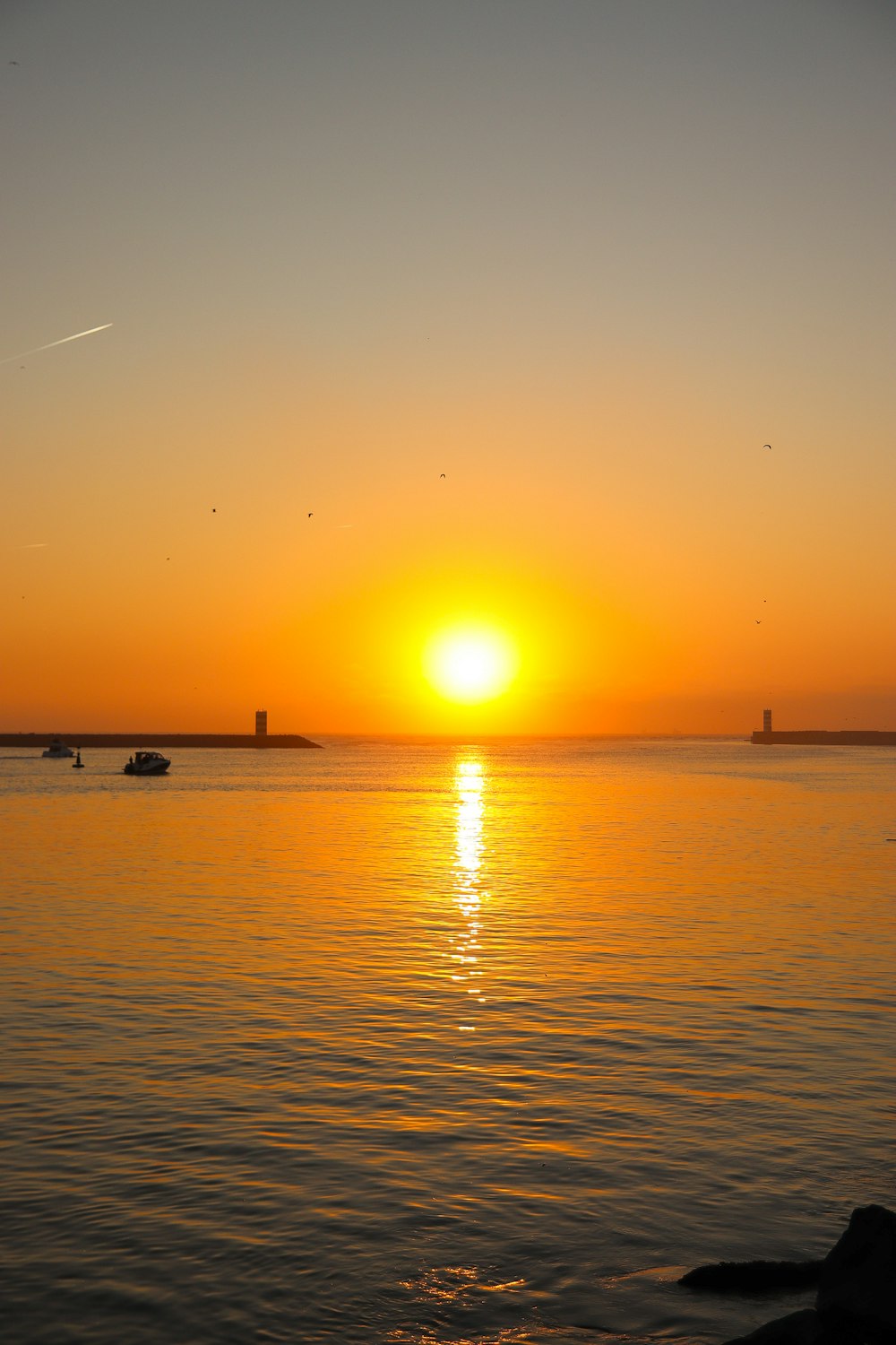 the sun is setting over a body of water