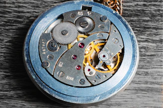 Close-up of a vintage mechanical watch movement with intricate gears and springs.