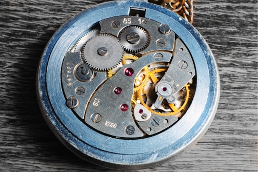 Close-up of a vintage watch mechanism with visible gears and springs.