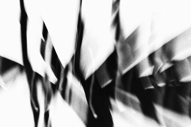 High-contrast abstract image of sharp black and white geometric shapes intersecting.