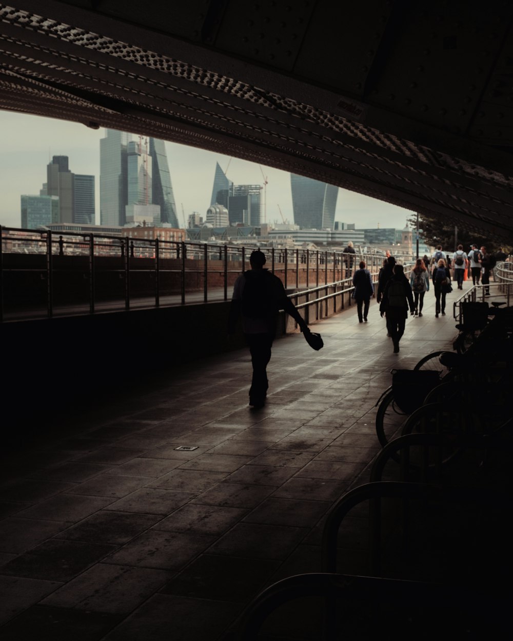 a group of people walking across a bridge