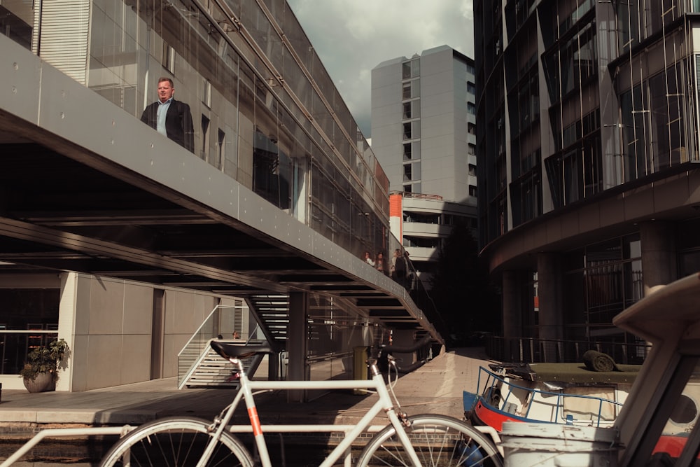 a man in a suit standing next to a bike