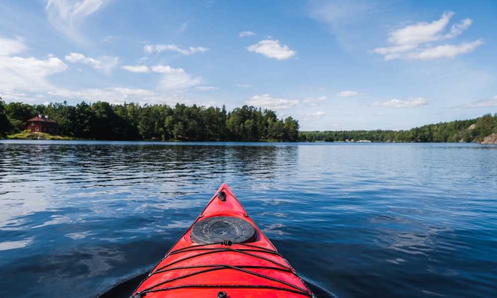 a red kayak in the middle of a lake