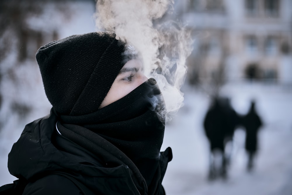 a person wearing a black hat and a black scarf