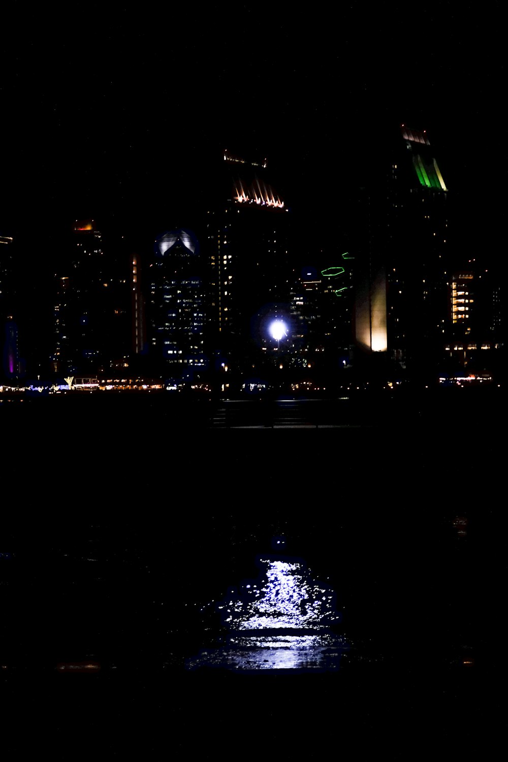 a view of a city at night from the water