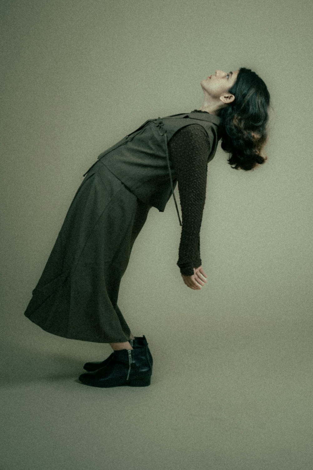 a woman in a black dress and black shoes