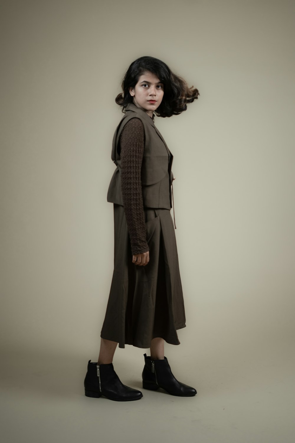 a woman standing in front of a white background