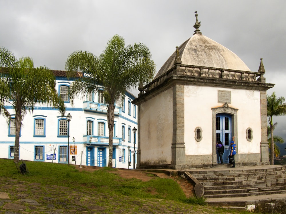 a white and blue building with steps leading up to it