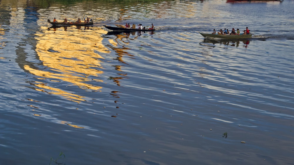 a group of boats floating on top of a lake