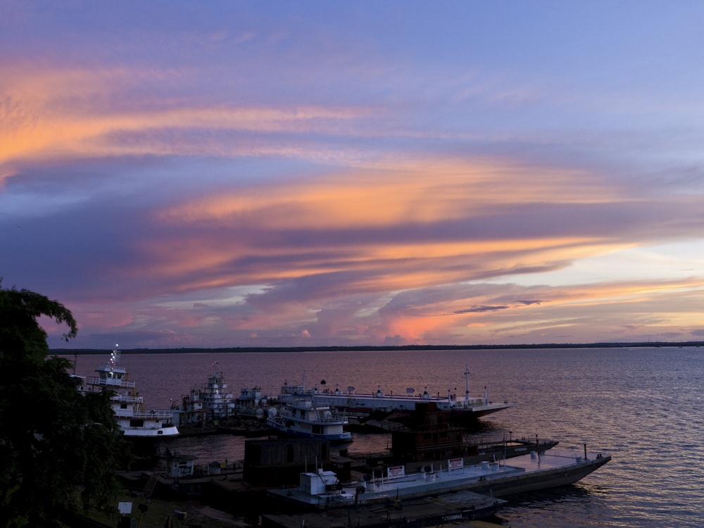 a boat is docked in the water at sunset