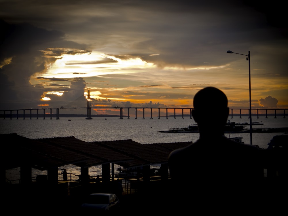 a person standing in front of a body of water