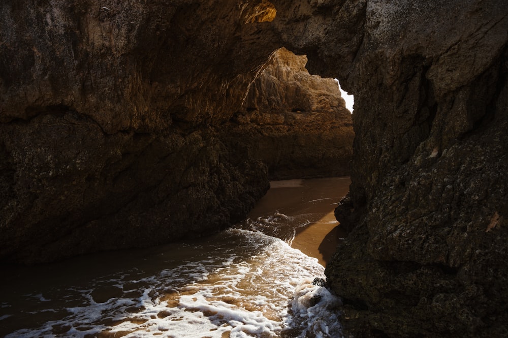 a cave with water coming out of it