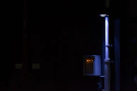 Emergency plumbing team responding quickly to a burst pipe in a dimly lit basement.