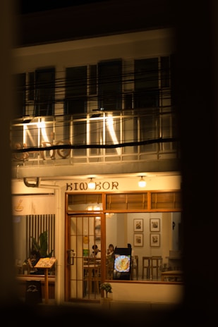 A vibrant photo of a cozy local restaurant's storefront in Joliette during golden hour.