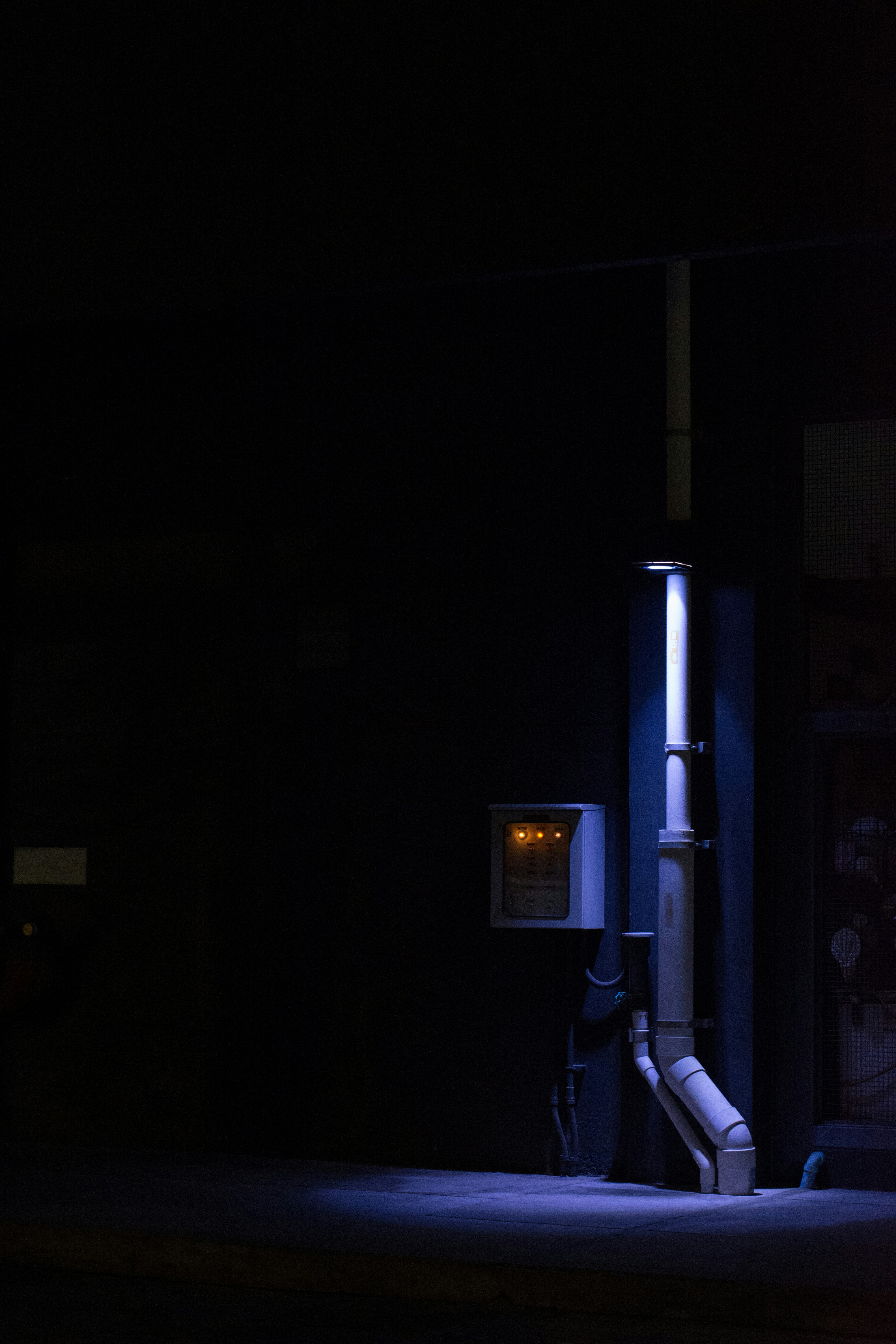 a street light sitting next to a building