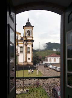 a view of a clock tower through an open door