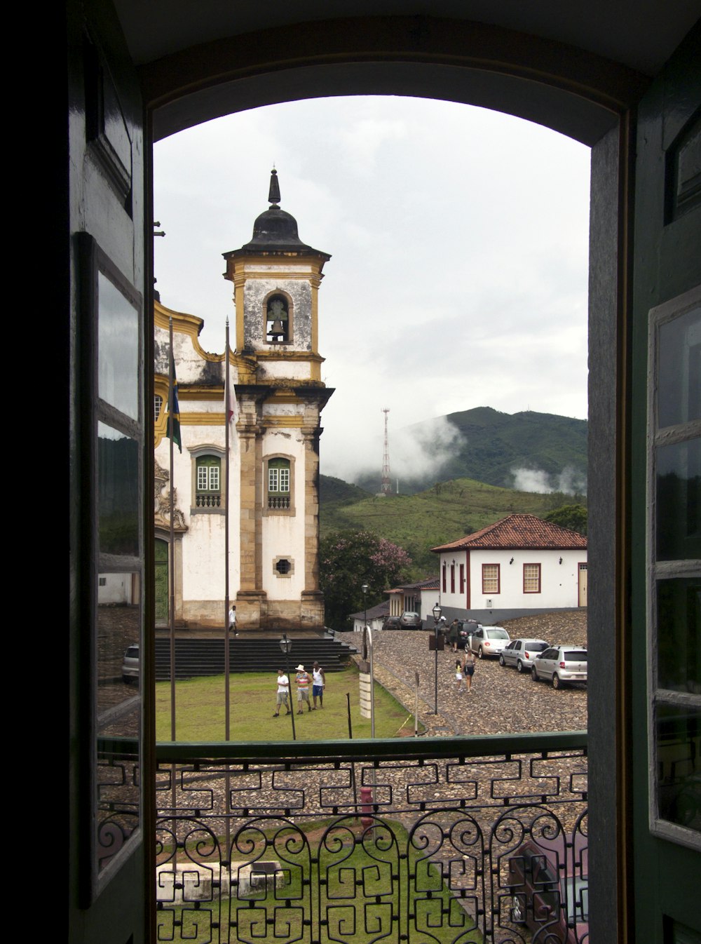 a view of a clock tower through an open door