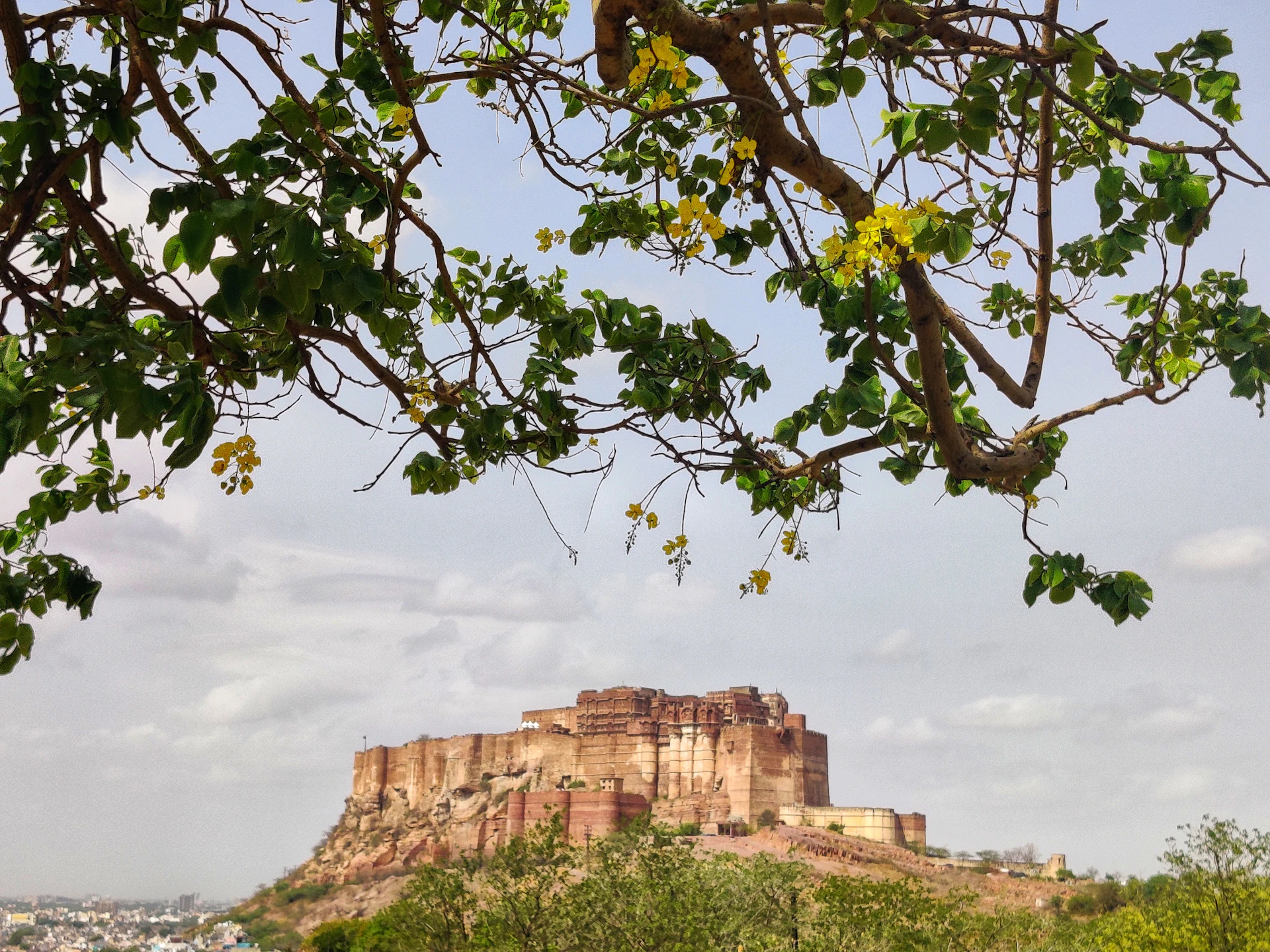 a view of a very tall hill with a castle on top of it
