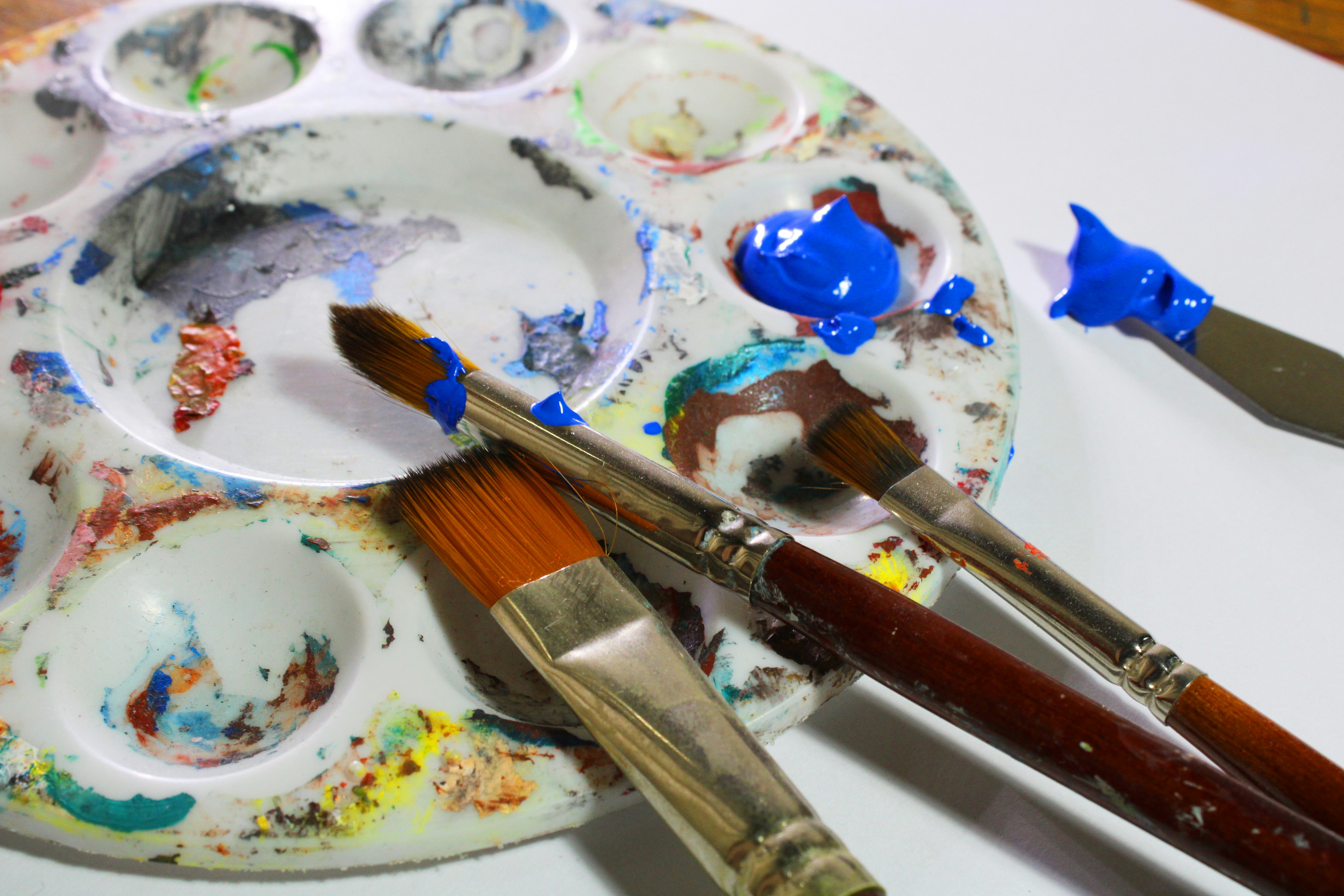 A plate with paint and brushes on it photo Free Paint container Image