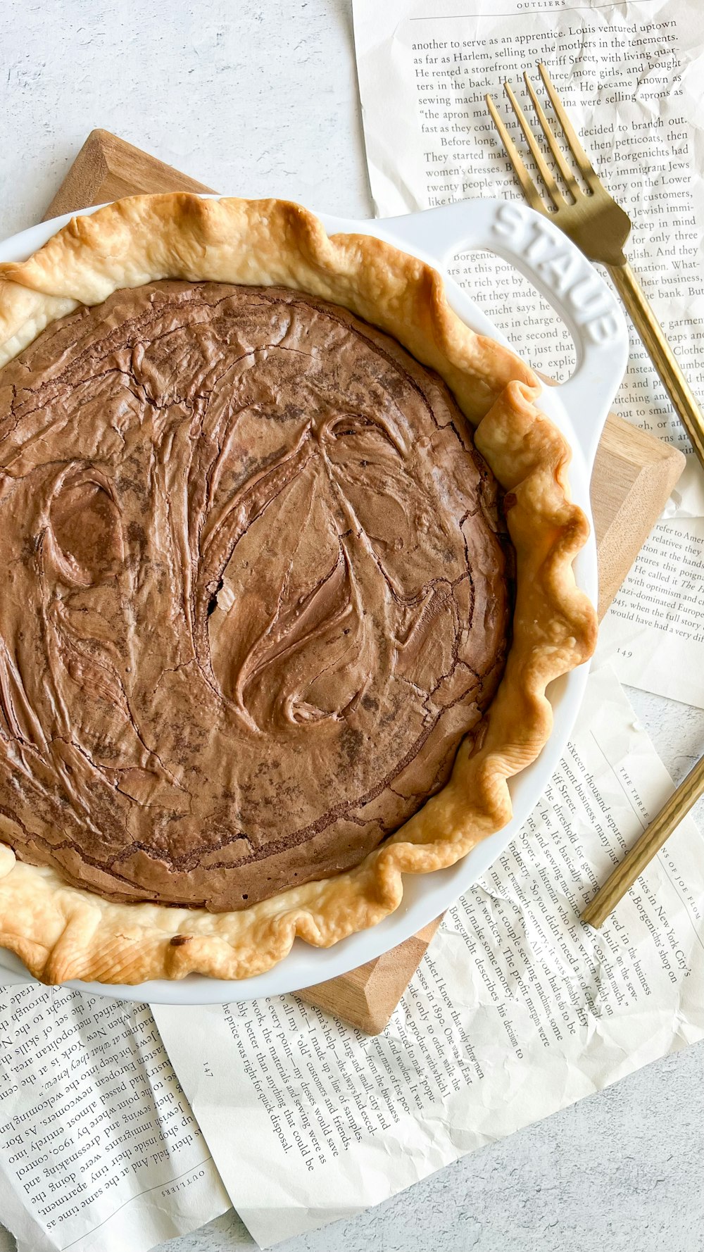 a chocolate pie sitting on top of a white plate