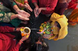 Members of Banjar Hitakarma preparing offerings with colorful flowers and fruits