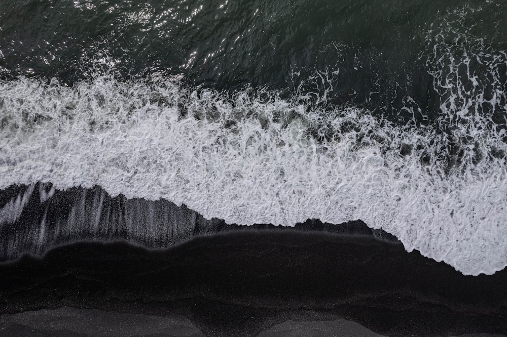 an aerial view of a black sand beach