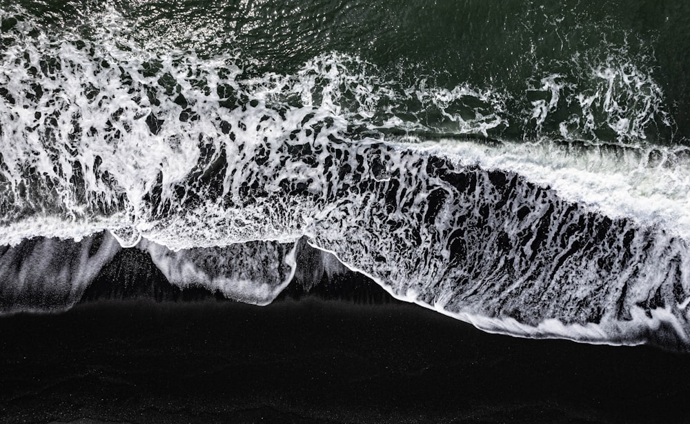 a black and white photo of the ocean waves