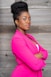 a woman in a pink suit posing for a picture