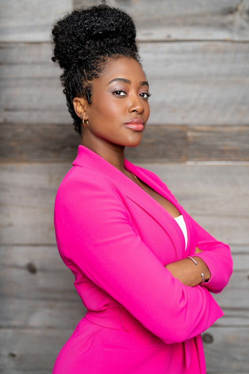 a woman in a pink suit posing for a picture