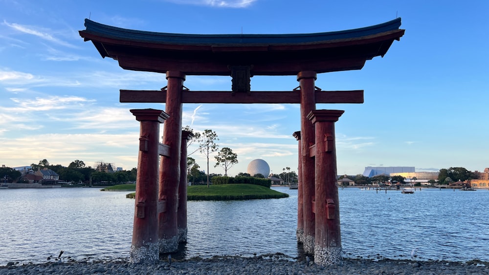 a large body of water next to a tall wooden structure