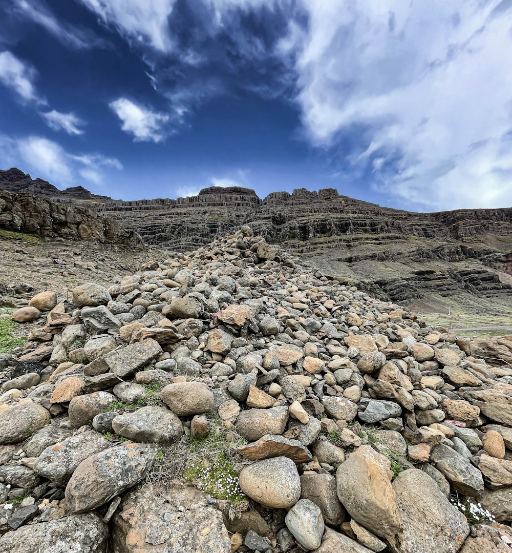 a large pile of rocks sitting on the side of a mountain