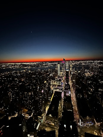 Aerial view of a cityscape at sunset showcasing vibrant colors and sharp details.