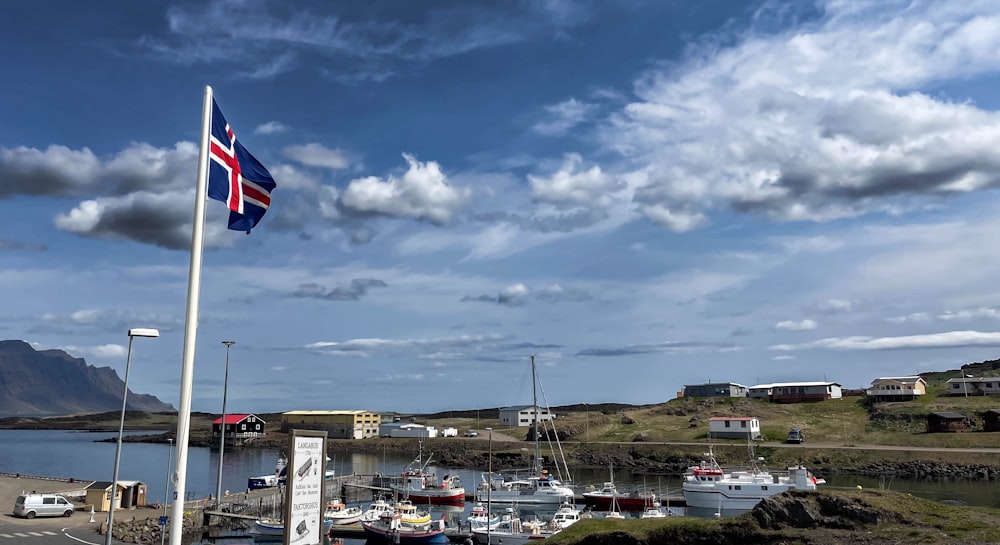 a british flag flying in front of a marina