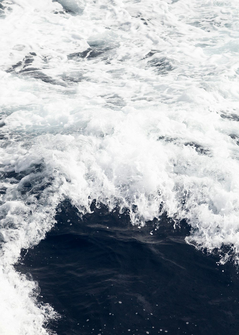 a person riding a surfboard on a wave in the ocean