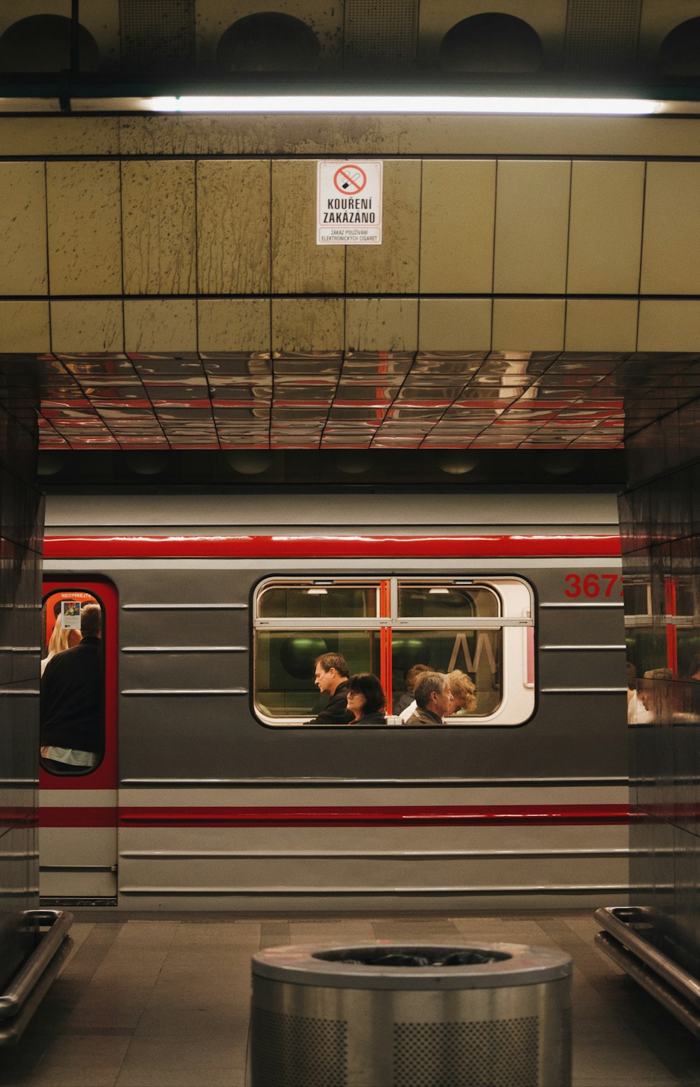 a subway train with people on the inside of it